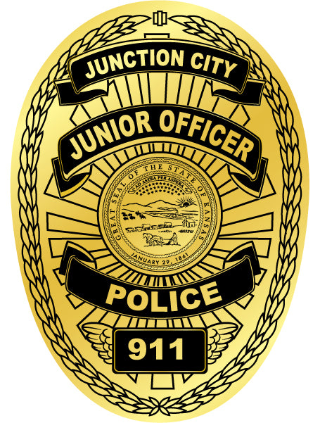 A gold and black oval badge design reading  JUNIOR OFFICER POLICE 911 with a central seal and decorative wreath border.